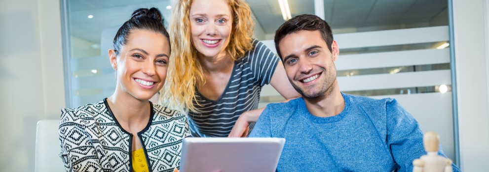 Three employees with a tablet