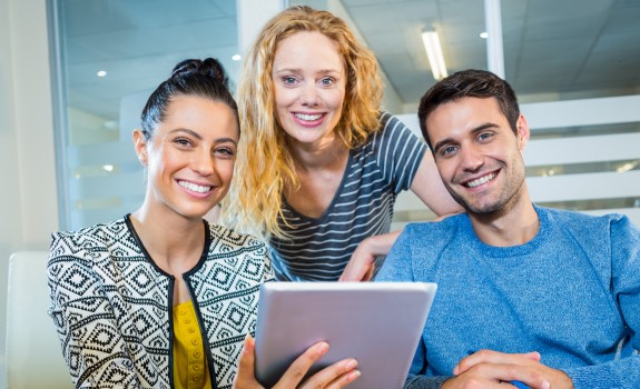 Three employees with a tablet