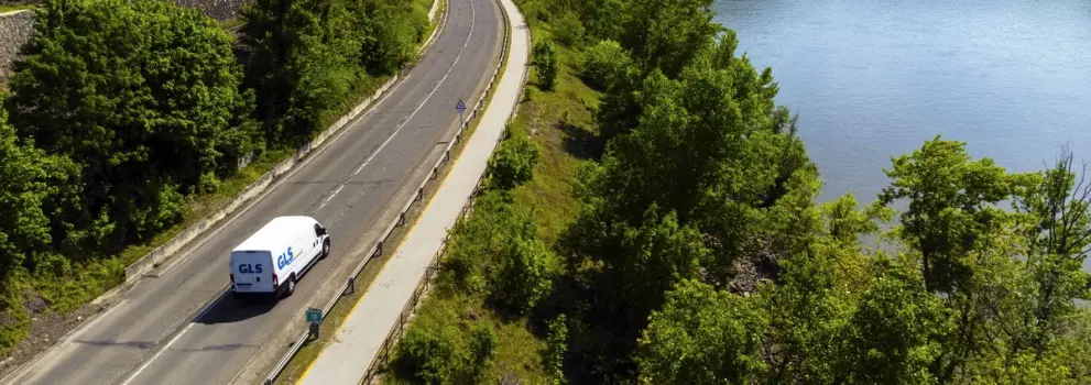 Electric delivery vehicle driving through nature