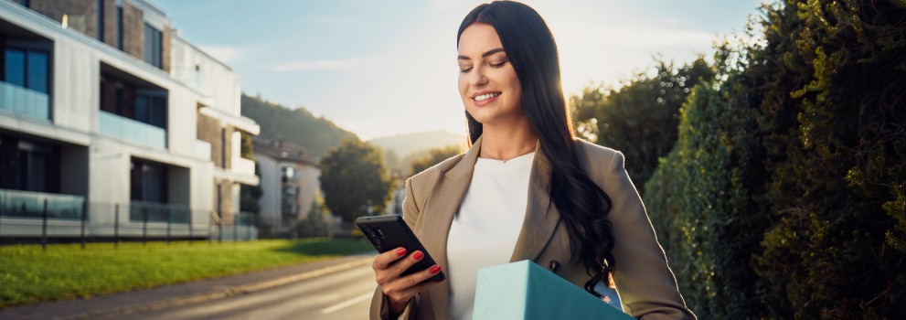 Customer with parcel looking at the phone